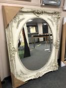 A large white oval panel mirror