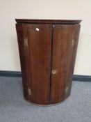 A Georgian oak hanging corner cupboard