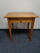 A pine side table fitted a drawer