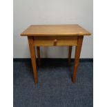 A pine side table fitted a drawer