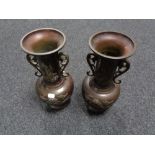 A pair of Chinese bronze twin handled embossed vases, height 33.5 cm.