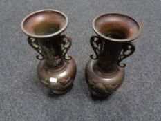 A pair of Chinese bronze twin handled embossed vases, height 33.5 cm.