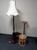 A wicker stool, magazine rack, standard lamp,