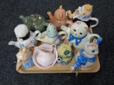 A tray of assorted novelty teapots