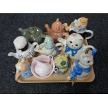 A tray of assorted novelty teapots
