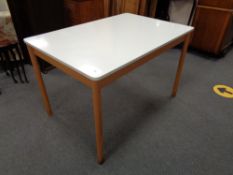 A mid 20th century Formica topped kitchen table and four chairs