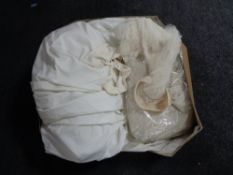 A vintage wedding dress and veil in box