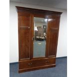 A late Victorian mahogany single door wardrobe fitted a drawer