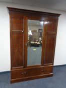 A late Victorian mahogany single door wardrobe fitted a drawer