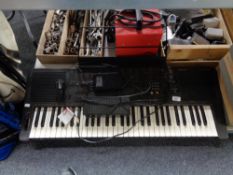 A Technics KN650 electric keyboard with foot pedal and stand