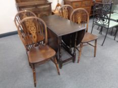 An oak drop leaf table and four chairs