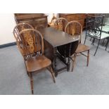 An oak drop leaf table and four chairs