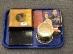 A Royal commemorative tin containing crowns, together with a Royal booklet,