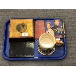 A Royal commemorative tin containing crowns, together with a Royal booklet,