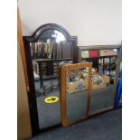 A 1970's frameless mirror on teak board together with two further mirrors