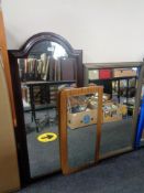 A 1970's frameless mirror on teak board together with two further mirrors