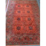 A machine made woolen rug on red ground