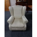 A Victorian style wingback armchair