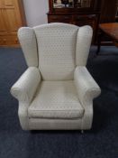 A Victorian style wingback armchair