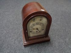An antique German dome topped mantel clock with silvered dial