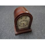 An antique German dome topped mantel clock with silvered dial