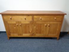 A contemporary pine four door sideboard