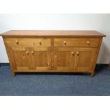 A contemporary pine four door sideboard