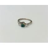 An 18ct gold emerald and diamond ring