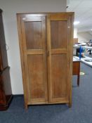 A 1930's oak Gentleman's wardrobe by Beavan of Newcastle 172 cm x 92 cm x 39 cm