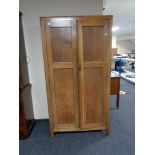 A 1930's oak Gentleman's wardrobe by Beavan of Newcastle 172 cm x 92 cm x 39 cm