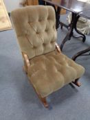 An upholstered brown dralon rocking chair