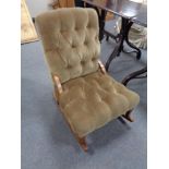 An upholstered brown dralon rocking chair