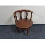 An antique mahogany leather upholstered armchair