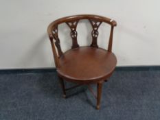 An antique mahogany leather upholstered armchair