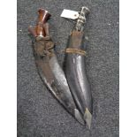 Two kukri knives in leather sheaths