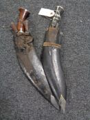 Two kukri knives in leather sheaths