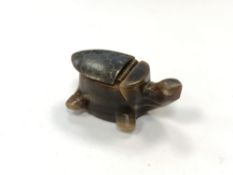 A vintage carved horn snuff box in the form of a turtle