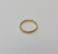 An 18ct gold band ring (misshapen) CONDITION REPORT: 2.