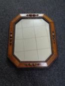 An Edwardian oak octagonal mirror