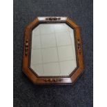 An Edwardian oak octagonal mirror
