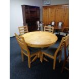 A circular pine kitchen table and four chairs plus an entertainment stand