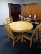 A circular pine kitchen table and four chairs plus an entertainment stand