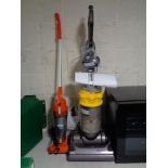 A Dyson DC 14 upright vac cleaner with tools and a Vax senior vac