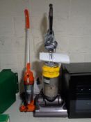 A Dyson DC 14 upright vac cleaner with tools and a Vax senior vac