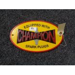 A metal Champions Spark plugs plaque