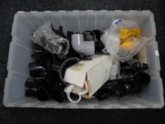 A box of plastic drain pipe fittings