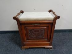 An antique mahogany fall front music stool