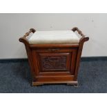 An antique mahogany fall front music stool