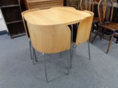 A contemporary kitchen table and four stow a way chairs