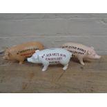 Three metal pig money boxes